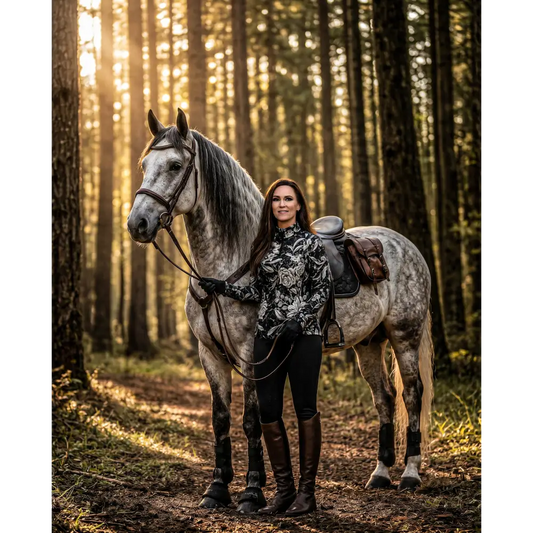 Dappled gray horse with dark mane wearing brown leather saddle and shadow bloom performance equestrian sun shirt upf50+