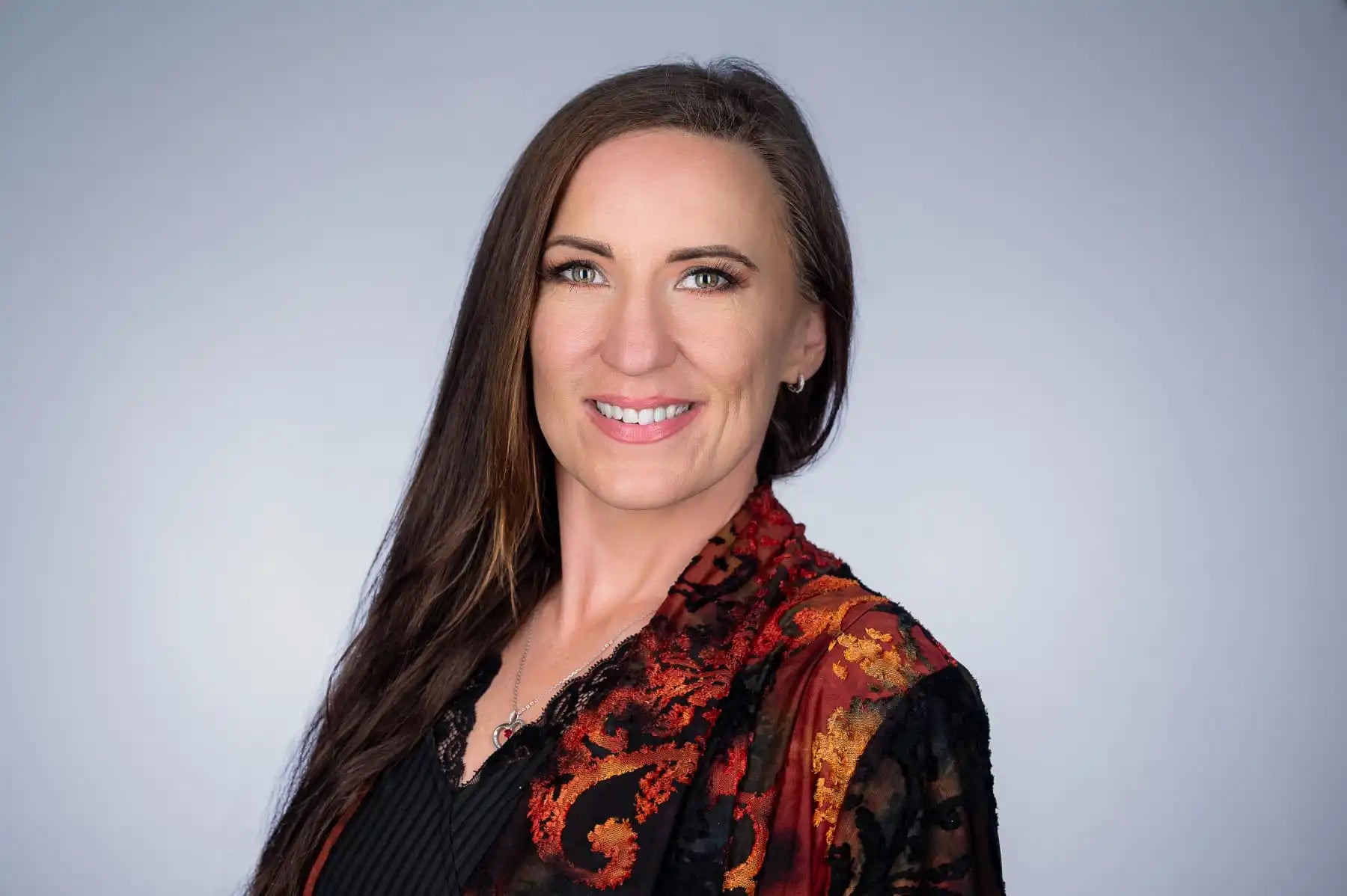 Smiling woman with long brown hair.
