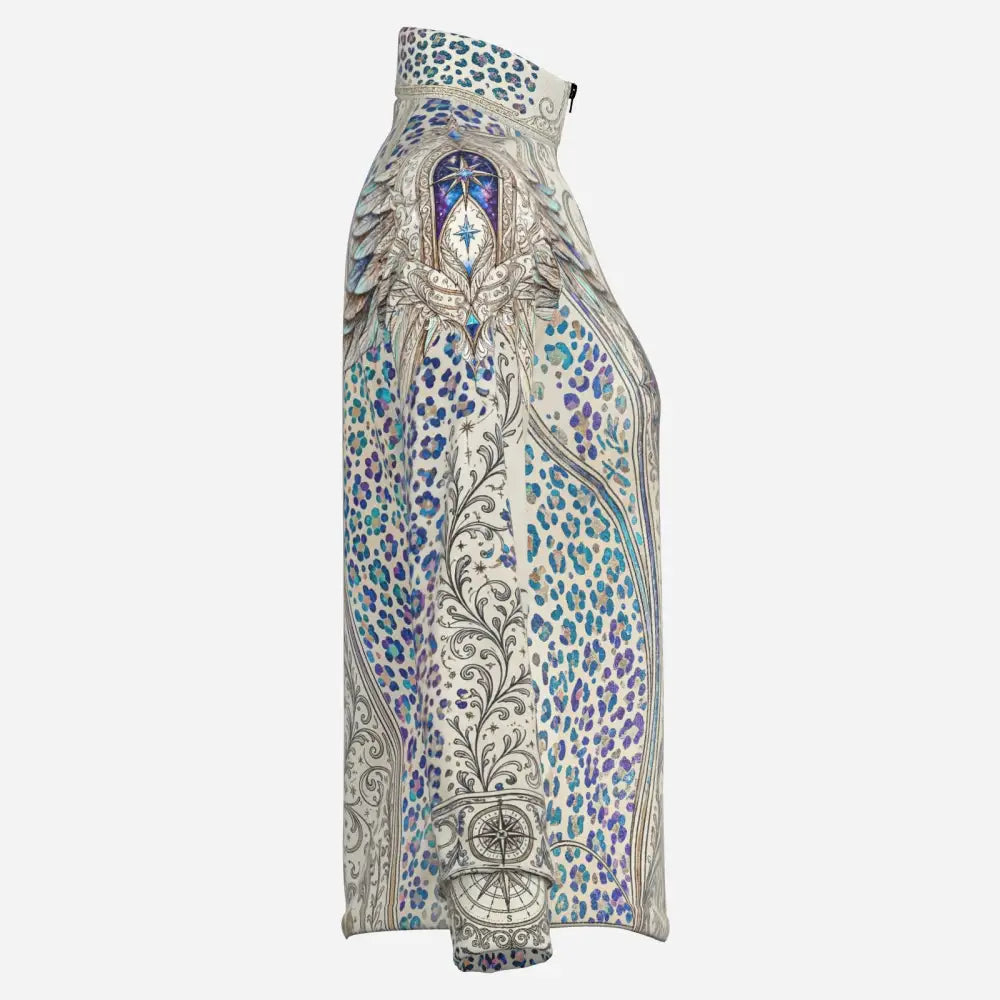 A high-necked cream blouse with blue and purple leopard print and silver wing and compass motifs in a soft quick dry fabric