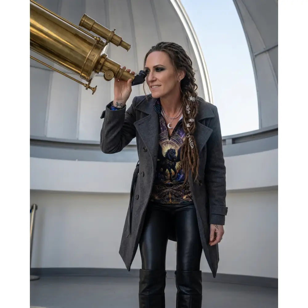 Brass telescope with ornate detailing and classic optical design featured in astral ascension performance equestrian sun shirt