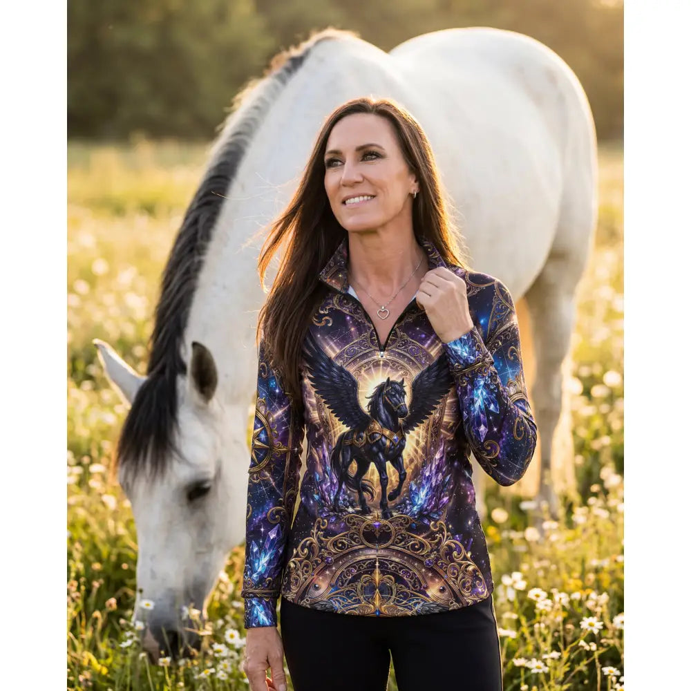 A woman wearing a long-sleeved astral ascension equestrian sun shirt with a cosmic black winged horse design