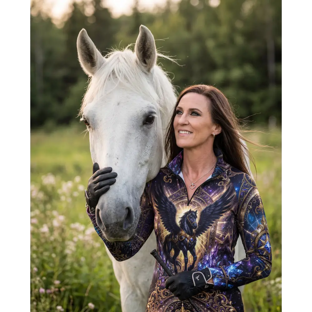 Woman wearing a long-sleeved galaxy equestrian sun shirt with ornate black winged horse and gold accents upf50+