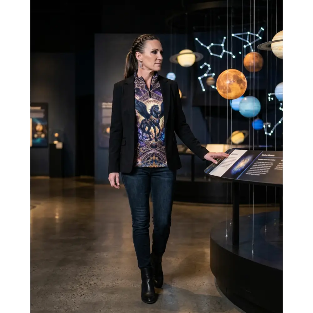 A woman wearing a black blazer over an astral ascension performance equestrian sun shirt with upf50+ protection
