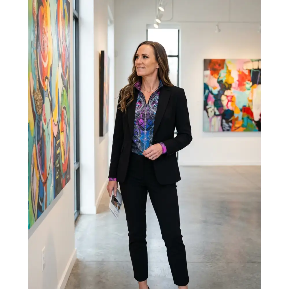Woman wearing midnight radiance performance equestrian sun shirt in vibrant purple blue teal under black blazer and pants