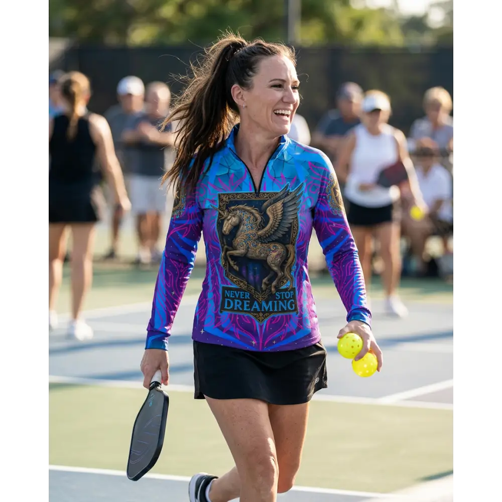 Vibrant blue and purple long-sleeved performance equestrian sun shirt with golden winged horse and never stop dreaming text
