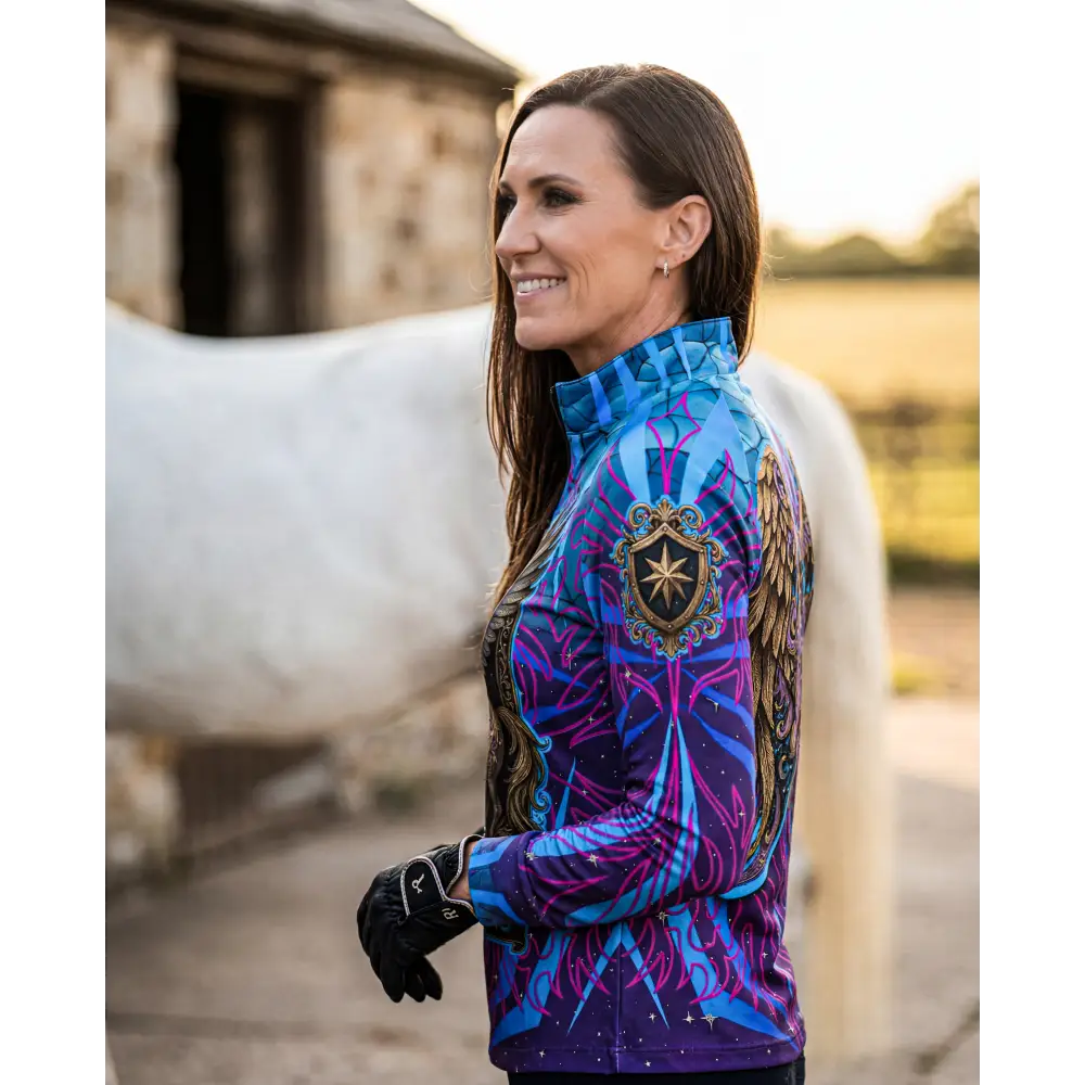 Vibrant blue and purple patterned performance equestrian sun shirt with ornate gold crest and upf50+ protection