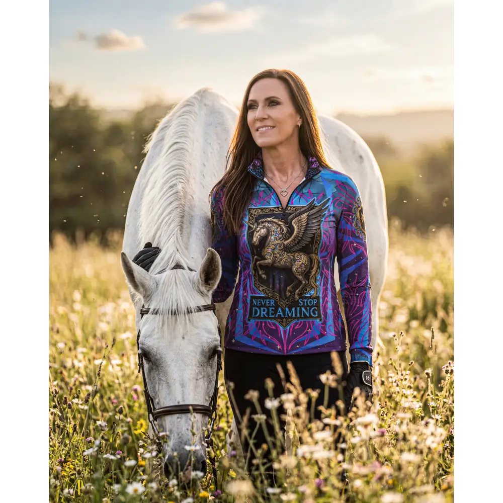 Vibrant purple and blue performance equestrian sun shirt with zip front winged horse graphic never stop dreaming text