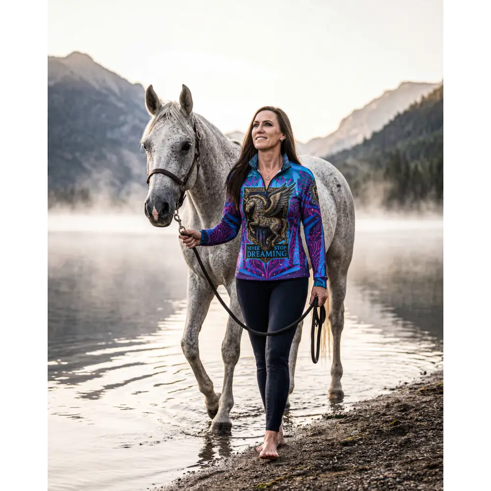 Never stop dreaming performance equestrian sun shirt in vibrant blue and purple with golden griffin graphic and upf50+ protection