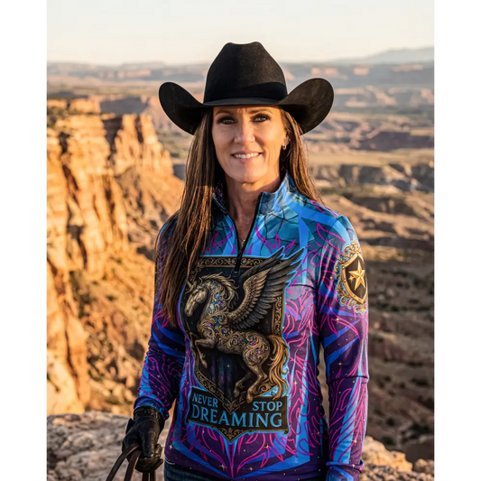 Never stop dreaming performance equestrian sun shirt in vibrant blue and purple with golden winged horse design and UPF50+ protection