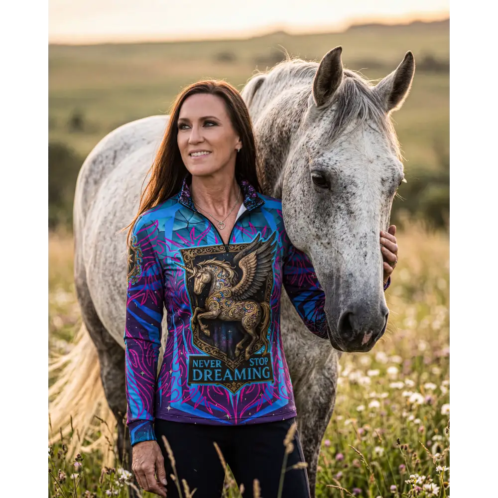 Never stop dreaming performance equestrian sun shirt upf50 plus in vibrant blue and purple with golden winged horse emblem