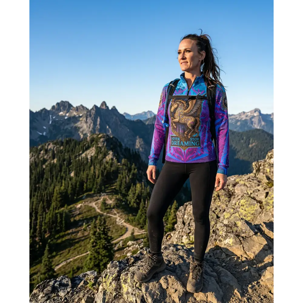 Vibrant purple and blue long-sleeved performance equestrian sun shirt with golden griffin graphic and never stop dreaming text