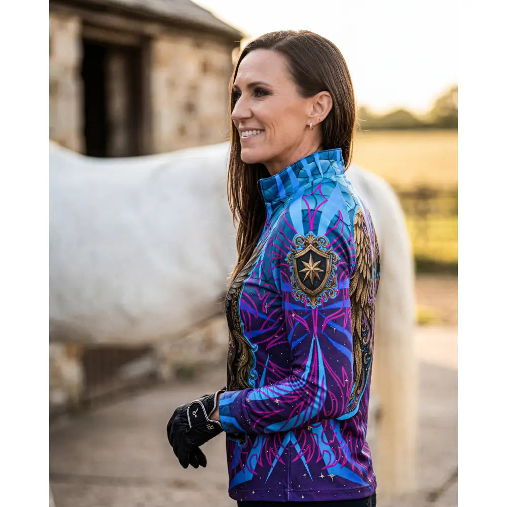 Vibrant blue and purple performance equestrian sun shirt with ornate gold crest and winged horse print for stop dreaming