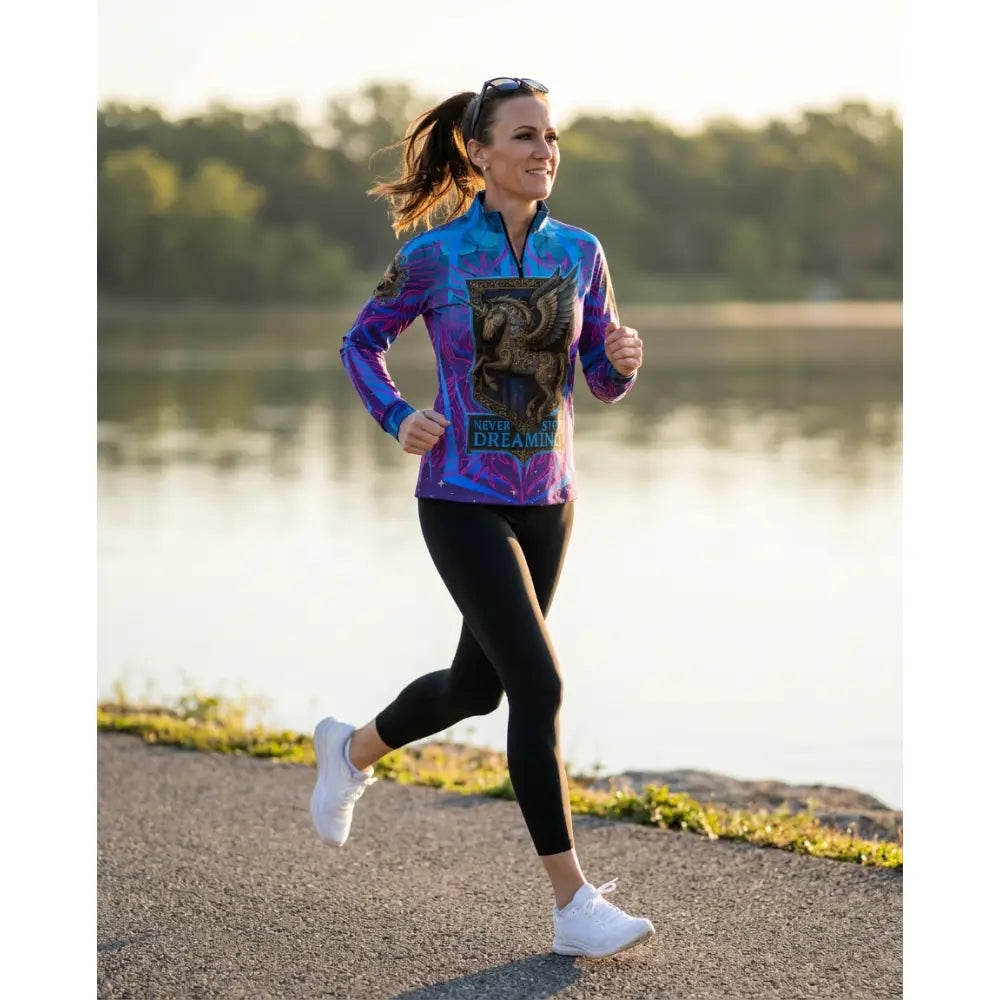 A vibrant purple and blue long-sleeved performance equestrian sun shirt with a black griffin graphic and stop dreaming text