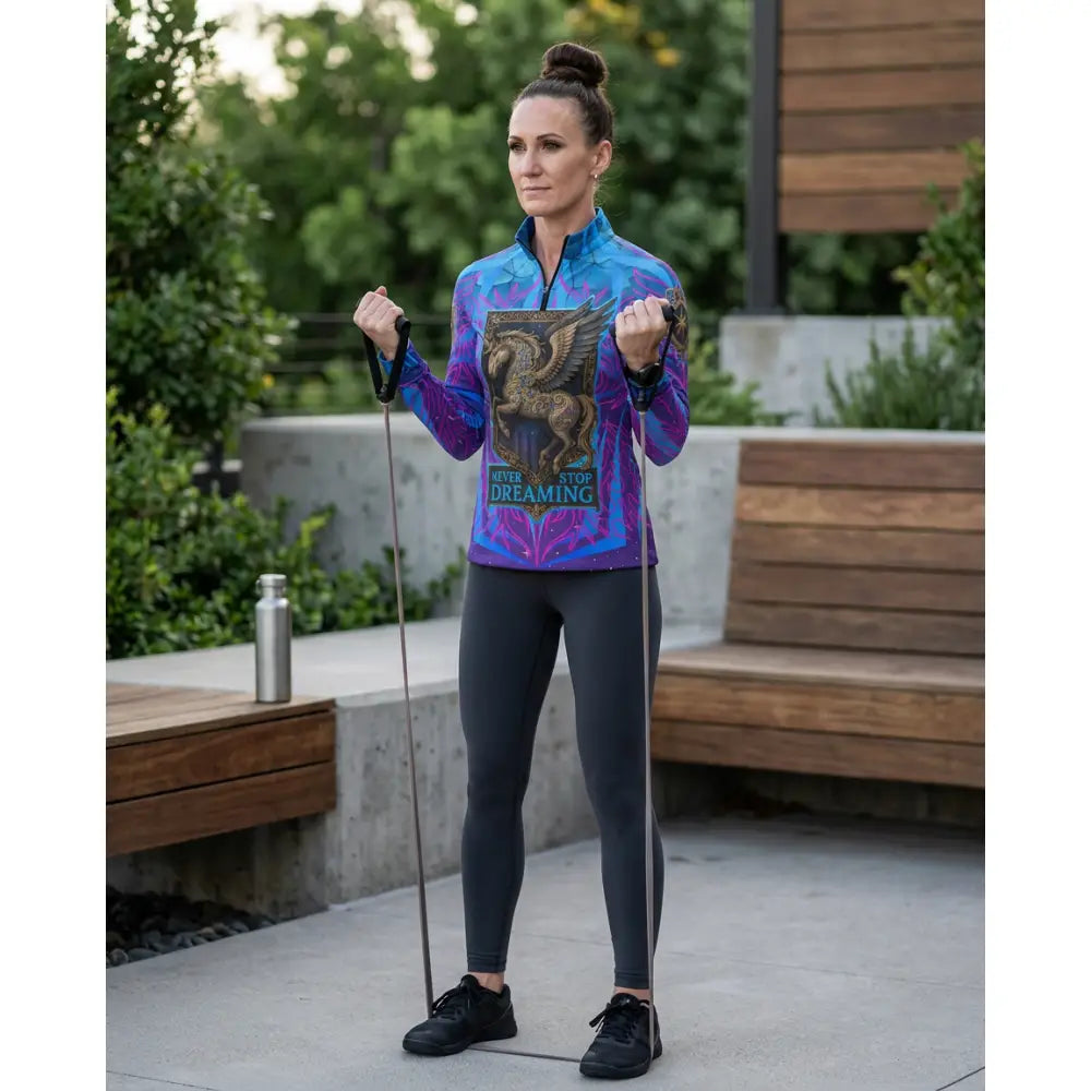Vibrant blue and purple long-sleeved equestrian sun shirt with golden winged horse and stop dreaming text for performance equestrian sun