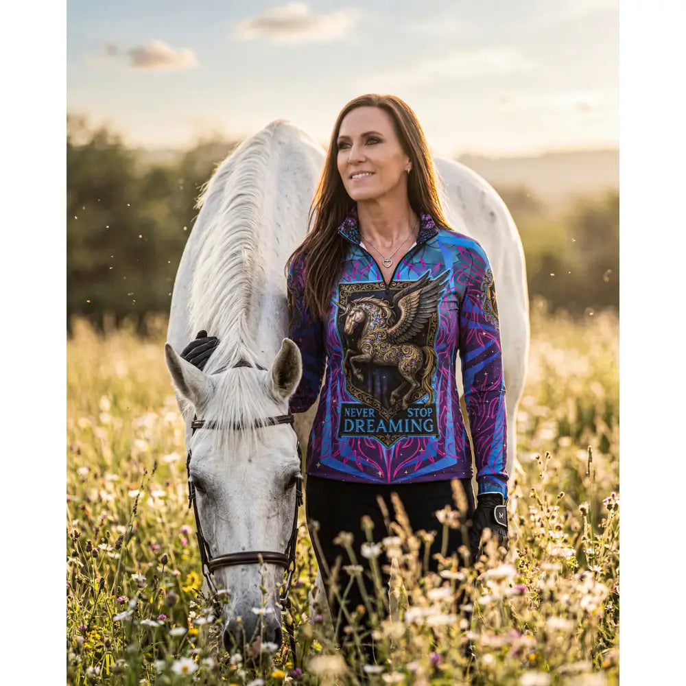 Vibrant purple and blue long-sleeved performance equestrian sun shirt with winged horse graphic and never stop dreaming text