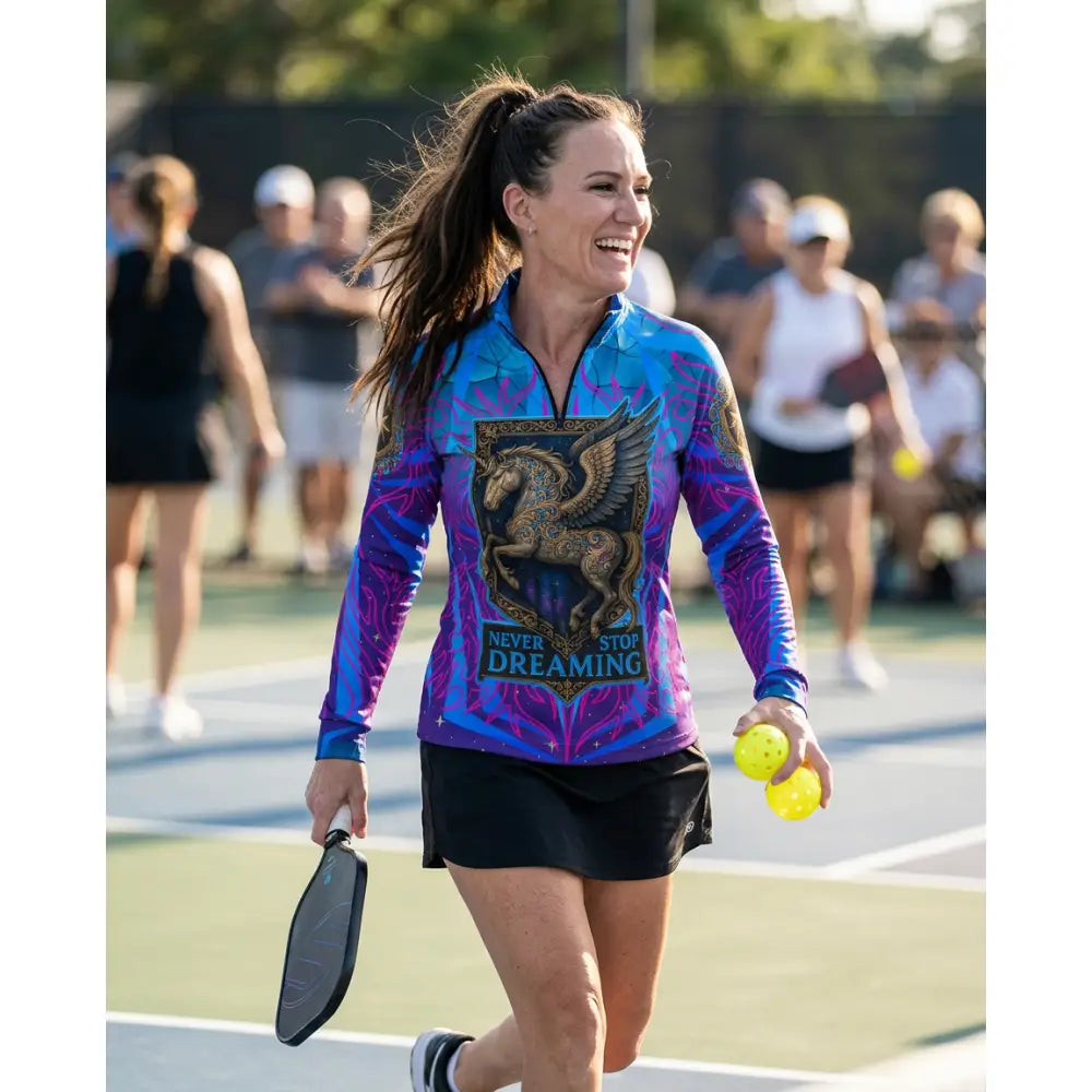 Vibrant blue and purple long-sleeved equestrian sun shirt with golden winged horse and stop dreaming text across chest