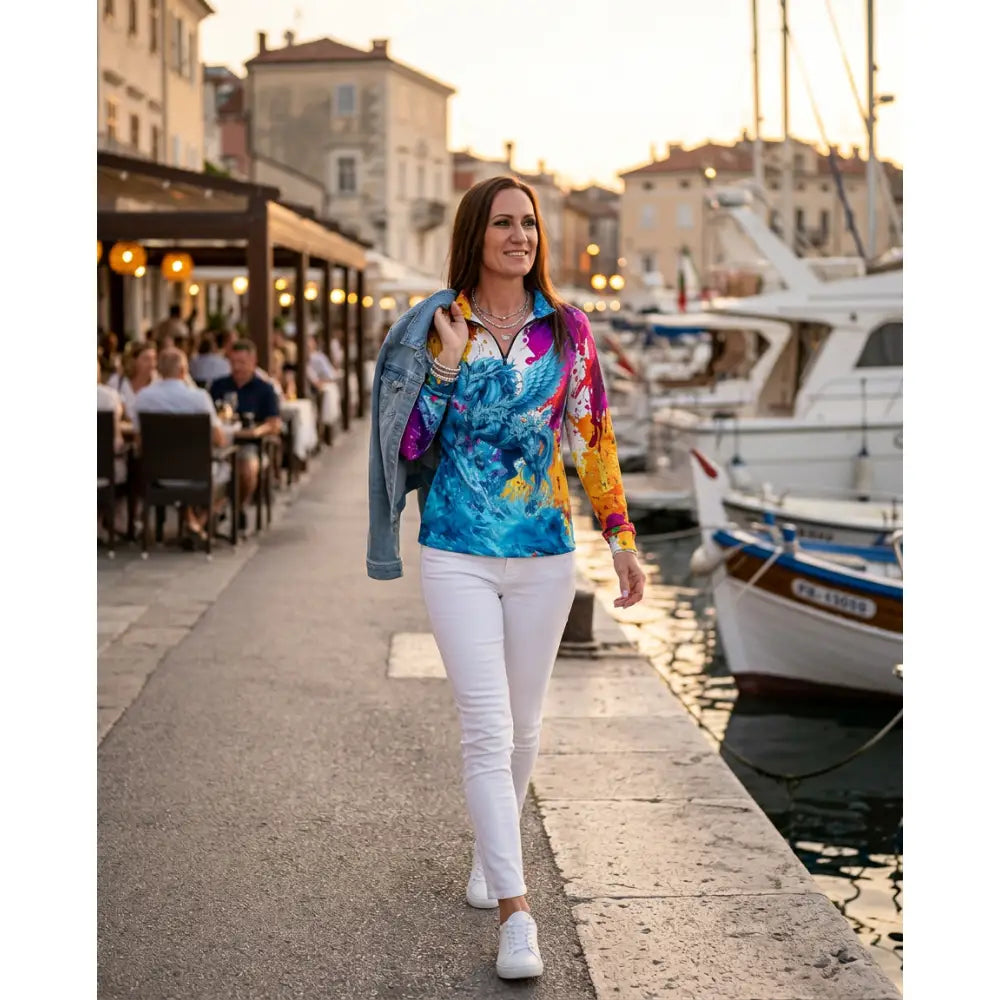 A vibrant riptide radiance long-sleeved equestrian sun shirt with a bold phoenix design in blue purple and orange from ripley signature collection wearable art