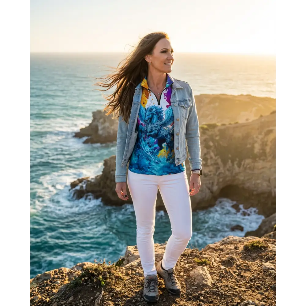 Woman wearing a blue and yellow floral print riptide radiance performance equestrian sun shirt with upf50 plus under denim jacket