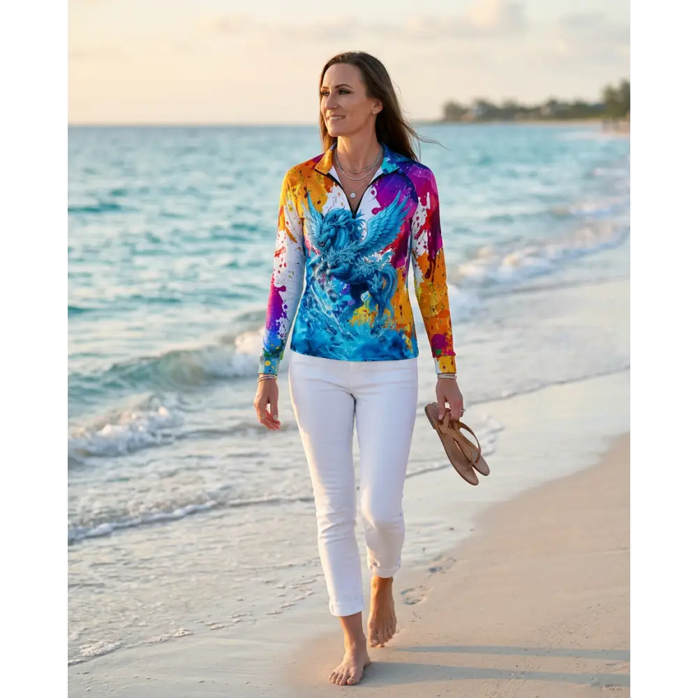 A vibrant long-sleeved riptide radiance performance equestrian sun shirt with a blue and purple winged creature design