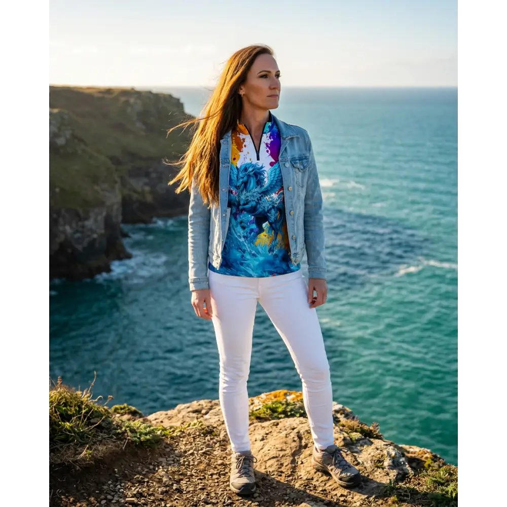 Woman wearing riptide radiance performance equestrian sun shirt in blue and purple tie-dye with denim jacket and white pants