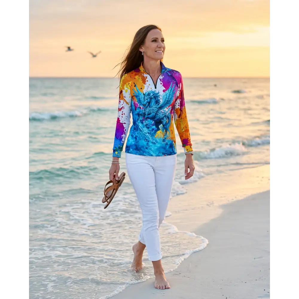 A vibrant long-sleeved uv-protective equestrian sun shirt with a colorful phoenix design in blue purple orange and yellow