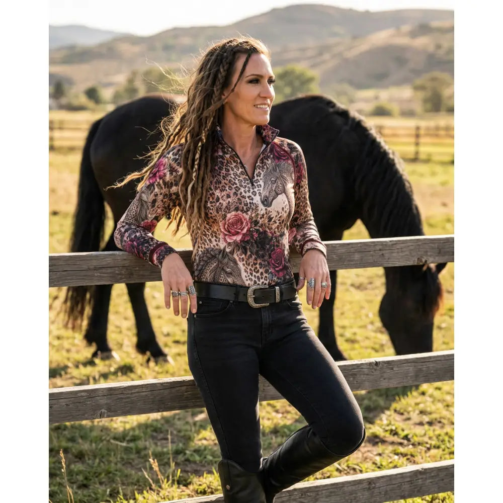 A woman wears a rosae equiferus equestrian sun shirt with leopard rose horse print in pink and brown shades