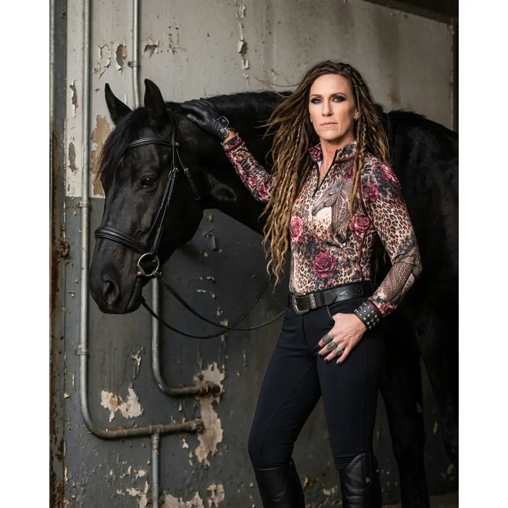 A woman wearing a long-sleeved rosae equiferus equestrian sun shirt with leopard rose horse print by karen reinertson
