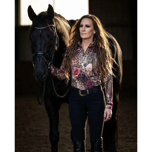A woman wearing a rosae equiferus equestrian sun shirt with leopard rose horse print by karen reinertson