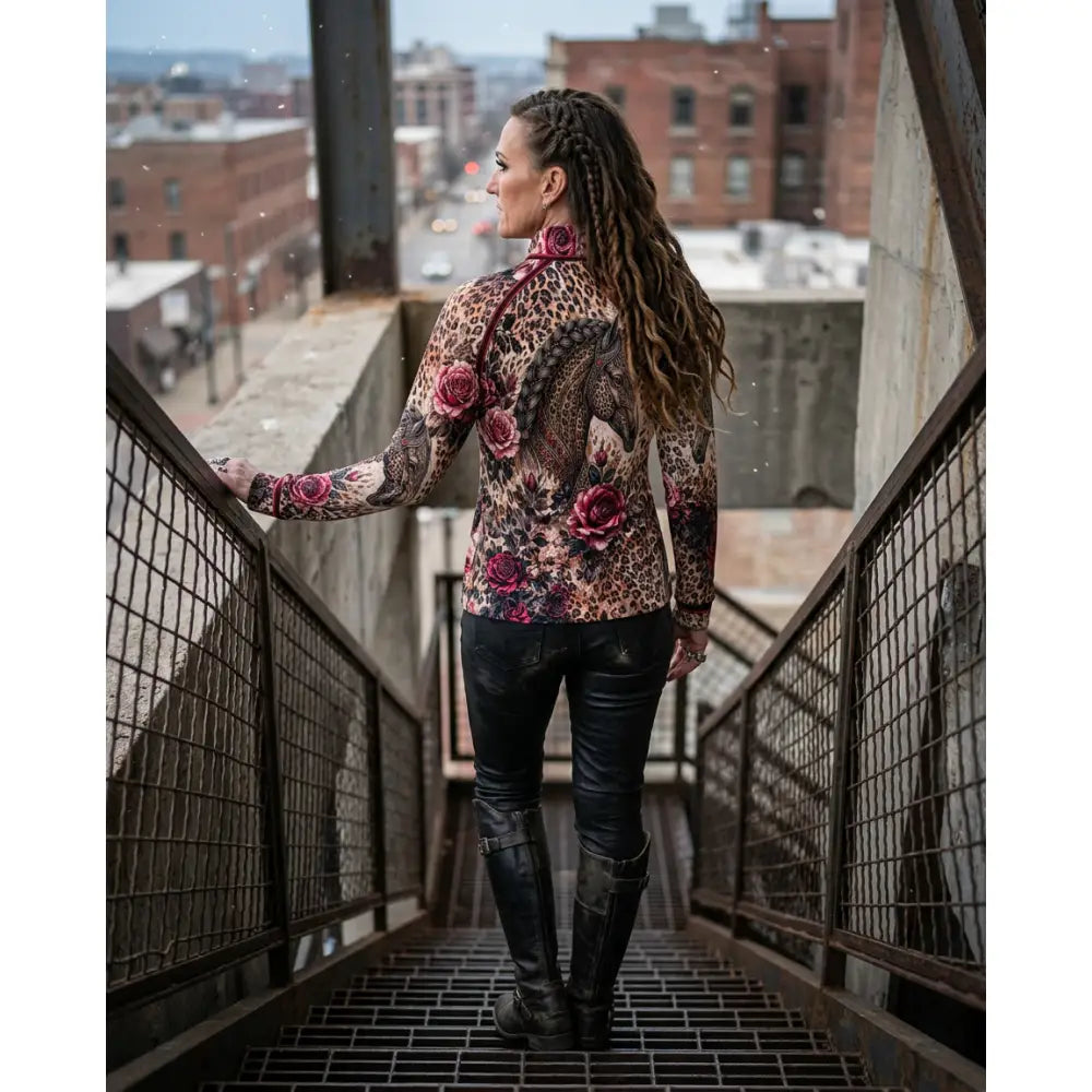 Woman wearing a long-sleeved leopard print rosae equiferus equestrian sun shirt by karen reinertson on urban stairs