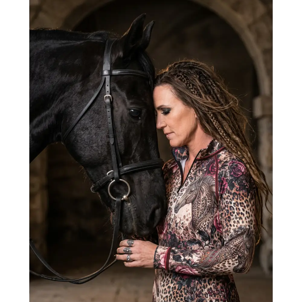 Woman wearing rosae equiferus upf50+ equestrian sun shirt with leopard floral pattern and pink rose horse graphic