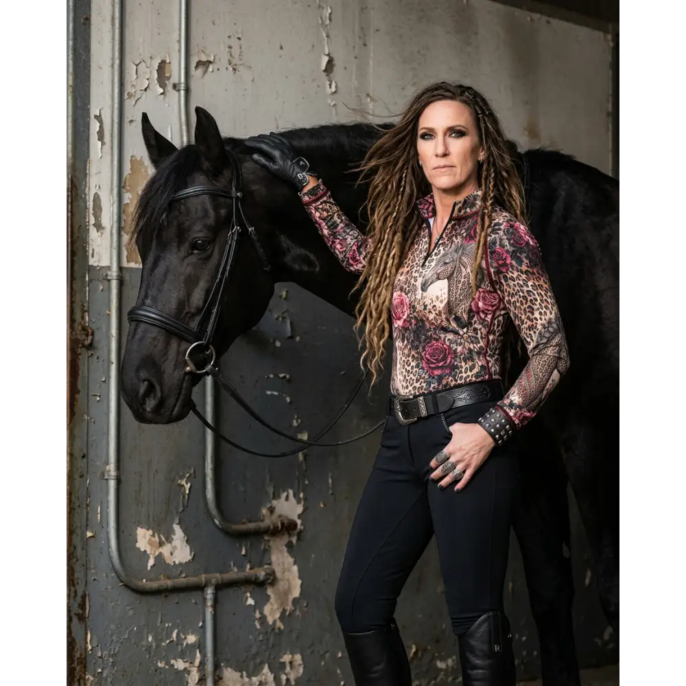 A woman wearing a long-sleeved leopard-print rosae equiferus upf50 equestrian sun shirt with rose and dragon motifs