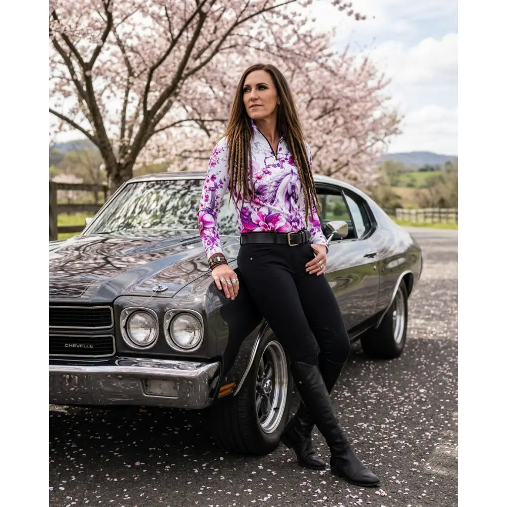 A dark gray metallic 1970s chevrolet chevelle with chrome accents featured alongside the sakura wildheart upf50+ sun shirt by karen reinertson