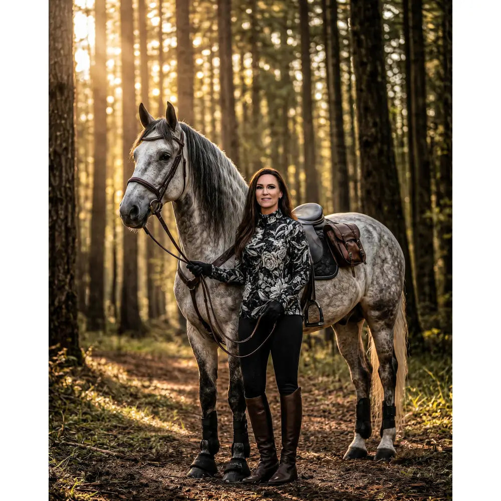 Dappled gray horse with dark mane and tail wearing a shadow bloom performance upf50+ equestrian sun shirt in monochrome floral