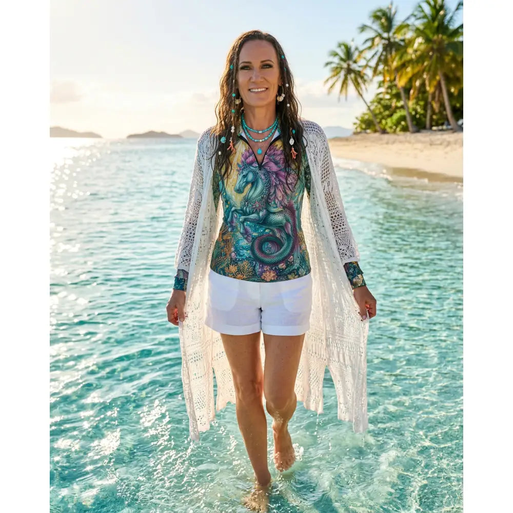Woman wearing colorful tidewoven reefborn ocean reef print performance apparel sun shirt with layered turquoise necklaces