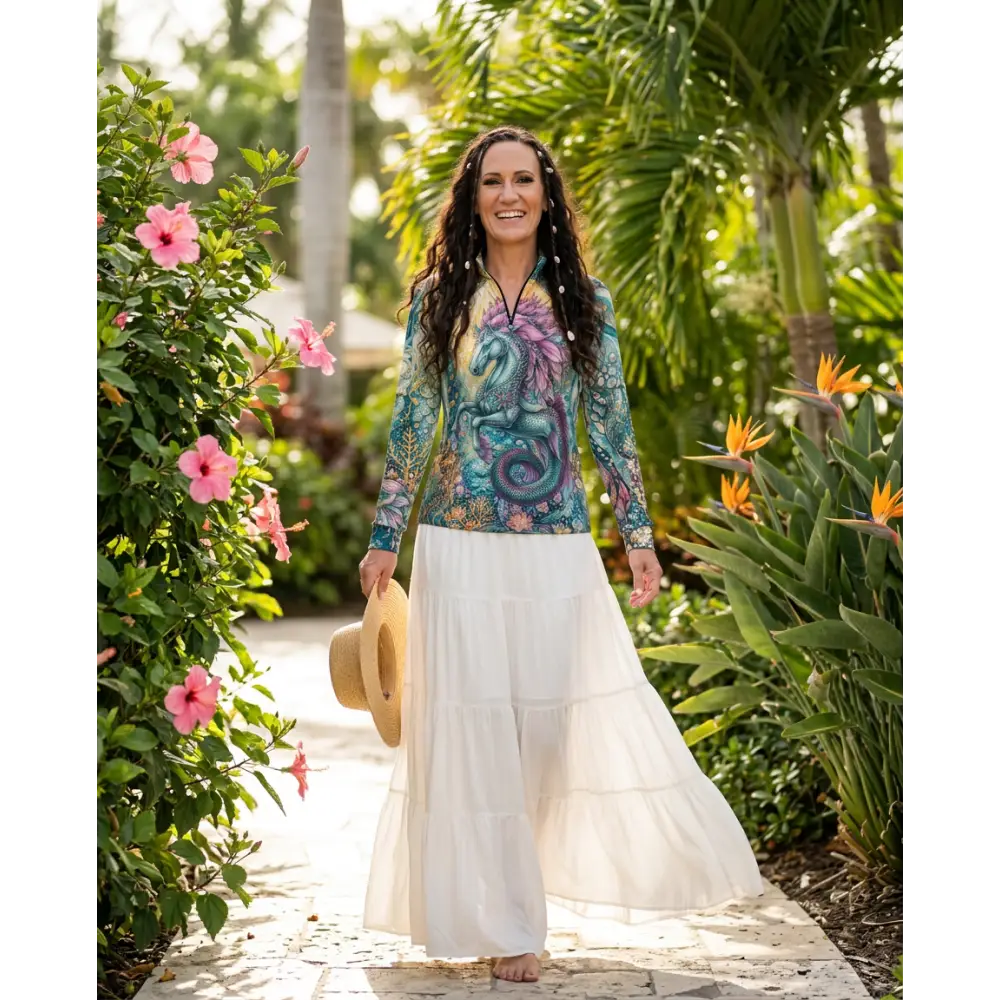 A vibrant long-sleeved tidewoven reefborn sun shirt with teal and purple dragon design and upf50+ sun protection