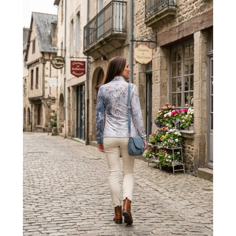 Blue crossbody bag with soft leather texture and minimalist design paired with unicornis caelestis equestrian sun shirt by karen reinertson