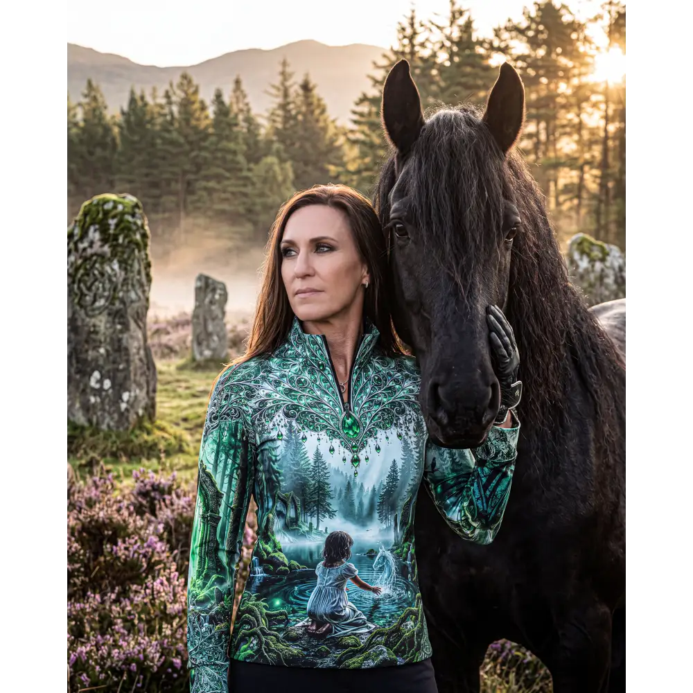 A woman wears a whispering waters performance equestrian sun shirt with glowing forest print and upf50+ protection